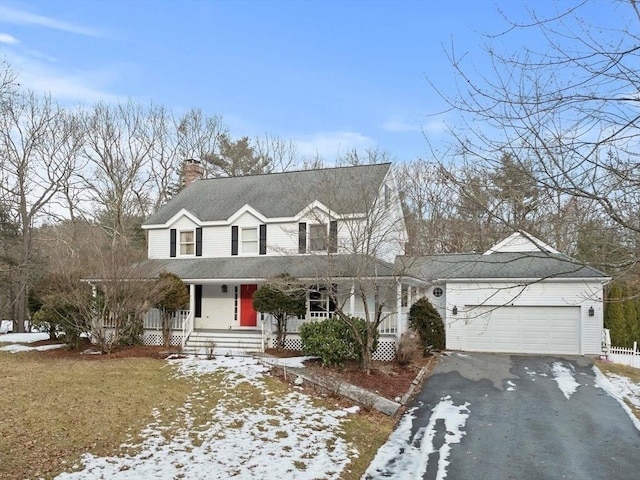 view of front of property featuring aphalt driveway, a chimney, a shingled roof, covered porch, and a garage