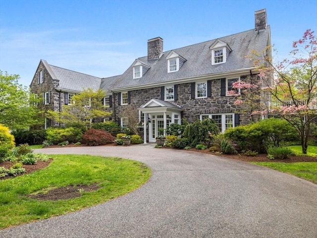 90 Burr Dr, Needham, MA 02492 - colonial home with a chimney, stone siding, and a high end roof