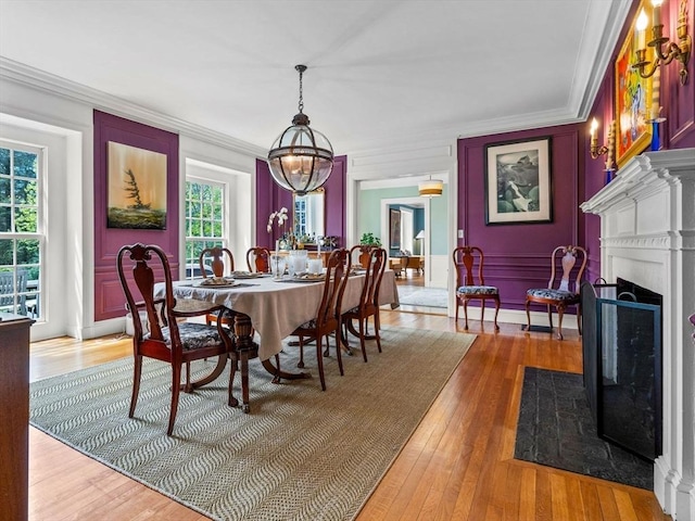 90 Burr Dr, Needham, MA 02492 - dining room with ornamental molding, light wood-type flooring, a fireplace with flush hearth, and a chandelier