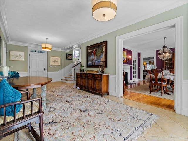 90 Burr Dr, Needham, MA 02492 - foyer entrance with tile patterned flooring, stairs, crown molding, and a wainscoted wall
