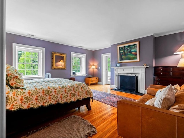 90 Burr Dr, Needham, MA 02492 - bedroom with wood finished floors, ornamental molding, multiple windows, and a fireplace