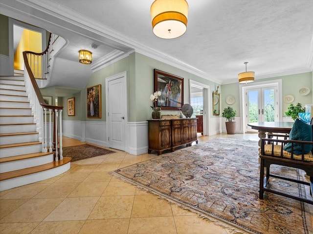 90 Burr Dr, Needham, MA 02492 - tiled entryway with french doors, crown molding, stairs, wainscoting, and a textured ceiling