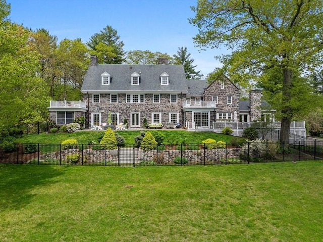 90 Burr Dr, Needham, MA 02492 - rear view of house with stone siding, a chimney, a fenced backyard, and a patio area