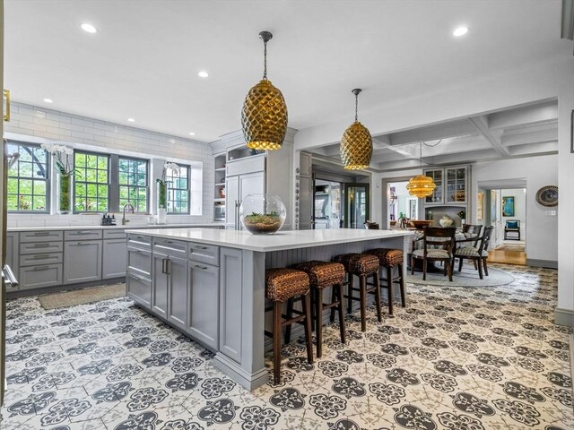 90 Burr Dr, Needham, MA 02492 - kitchen with gray cabinets, recessed lighting, light countertops, a spacious island, and coffered ceiling