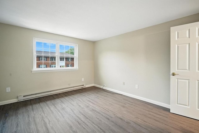 2 Maple Crest Cir Unit F, Holyoke, MA 01040 - spare room featuring a baseboard heating unit and wood finished floors