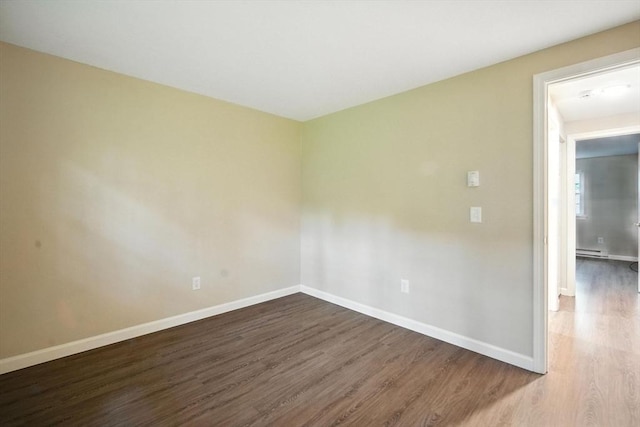 2 Maple Crest Cir Unit F, Holyoke, MA 01040 - empty room with wood finished floors and a baseboard radiator