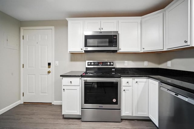 2 Maple Crest Cir Unit F, Holyoke, MA 01040 - kitchen featuring stainless steel appliances, light wood-style flooring, white cabinetry, and dark countertops