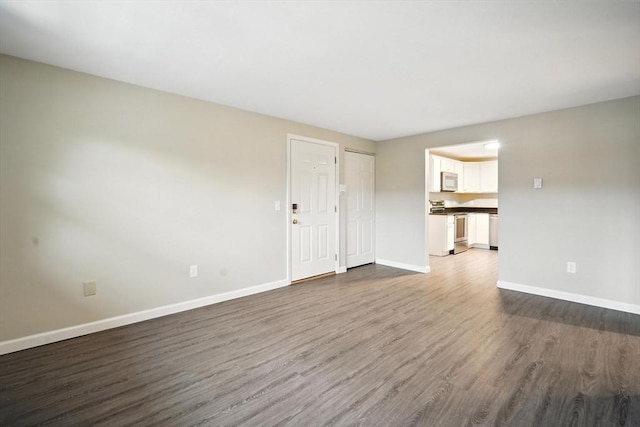 2 Maple Crest Cir Unit F, Holyoke, MA 01040 - unfurnished living room featuring dark wood finished floors and baseboards