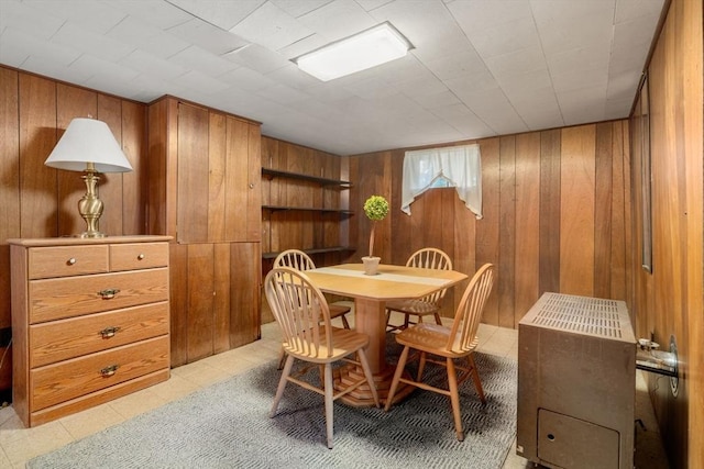 dining room with wooden walls