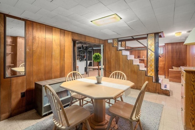 dining space featuring wooden walls