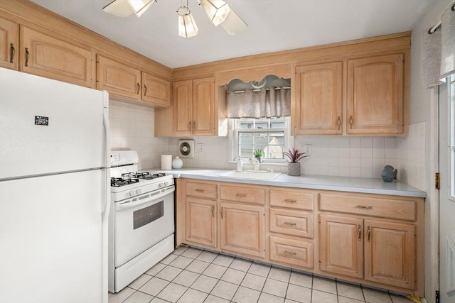 kitchen featuring ceiling fan, sink, tasteful backsplash, white appliances, and light tile patterned flooring