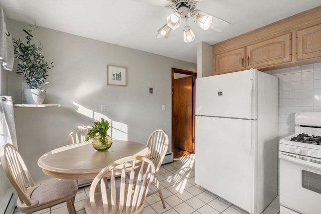 kitchen featuring white appliances, a baseboard heating unit, ceiling fan, light tile patterned floors, and light brown cabinetry