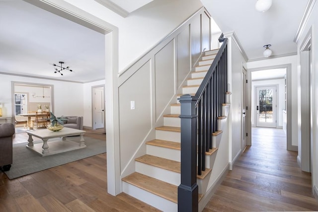 stairway featuring crown molding and wood-type flooring