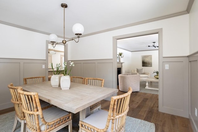 dining space featuring crown molding and hardwood / wood-style floors