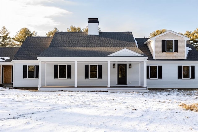 view of snow covered back of property