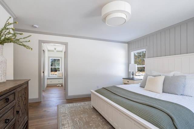 bedroom featuring multiple windows, ornamental molding, and dark wood-type flooring