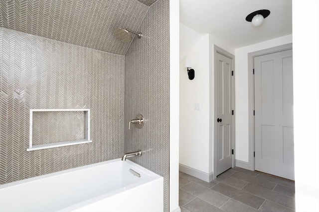 bathroom with tiled shower / bath and tile patterned flooring