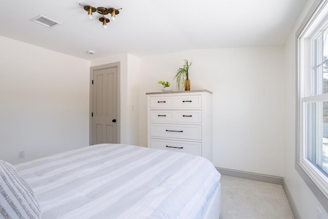 carpeted bedroom with multiple windows