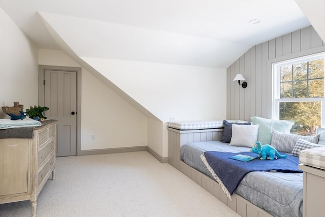 bedroom with light colored carpet and lofted ceiling