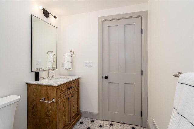 bathroom with vanity and toilet