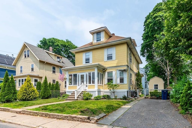 67 Gardner, Boston, MA 02132 - traditional style home featuring a front lawn, driveway, and a sunroom