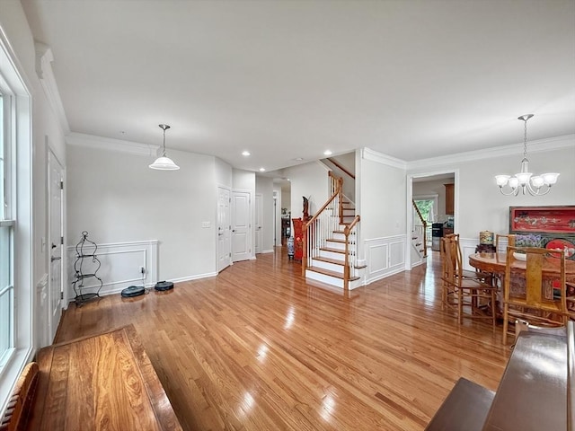 12 Grandview Dr Unit 12, Hopkinton, MA 01748 - living room featuring stairs, light wood finished floors, ornamental molding, a baseboard radiator, and a chandelier