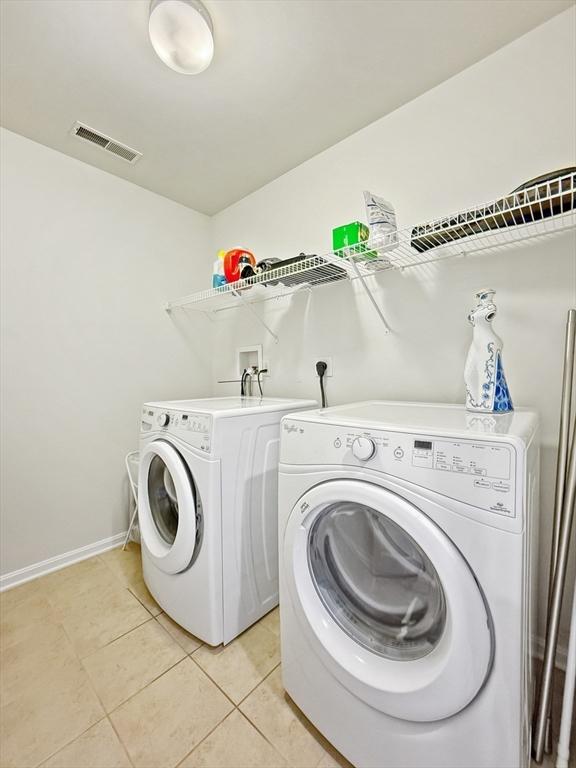 12 Grandview Dr Unit 12, Hopkinton, MA 01748 - laundry area featuring washer and clothes dryer and light tile patterned floors