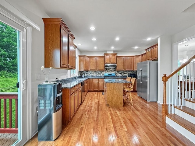 12 Grandview Dr Unit 12, Hopkinton, MA 01748 - kitchen featuring appliances with stainless steel finishes, light wood-style flooring, a breakfast bar area, brown cabinetry, and recessed lighting