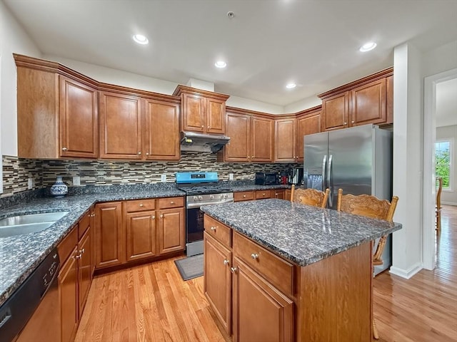 12 Grandview Dr Unit 12, Hopkinton, MA 01748 - kitchen featuring stainless steel appliances, light wood finished floors, under cabinet range hood, brown cabinets, and a kitchen island