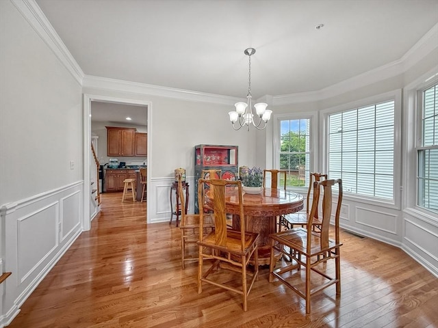 12 Grandview Dr Unit 12, Hopkinton, MA 01748 - dining area with a decorative wall, crown molding, a chandelier, healthy amount of natural light, and light wood-style flooring