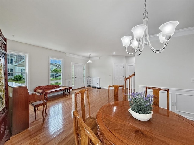 12 Grandview Dr Unit 12, Hopkinton, MA 01748 - dining room featuring light wood-style flooring, a chandelier, and a wainscoted wall