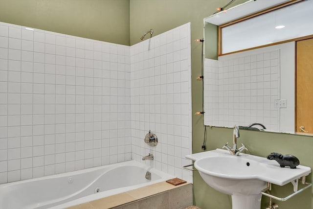 full bathroom with tiled shower / bath and a sink