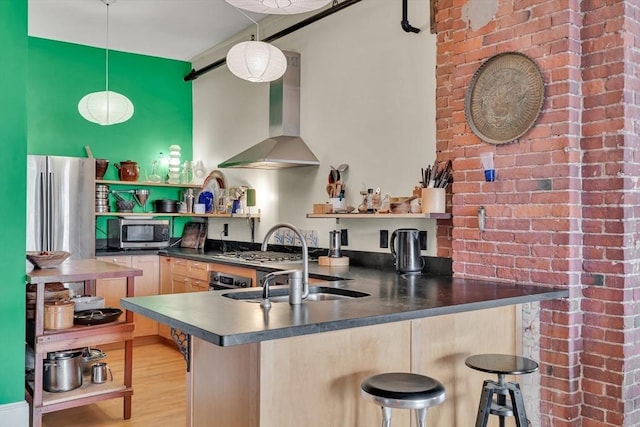 kitchen with open shelves, stainless steel microwave, a sink, dark countertops, and light brown cabinetry