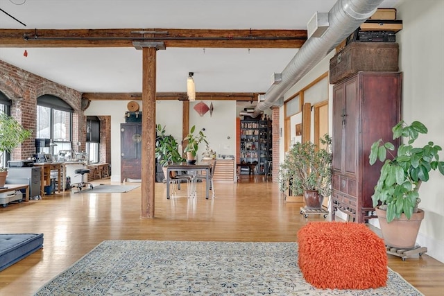 foyer entrance with wood finished floors and beamed ceiling