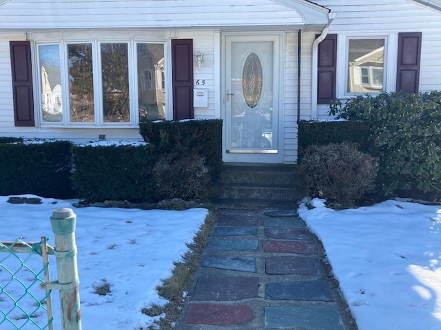 view of snow covered property entrance