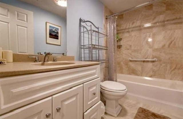 bathroom featuring shower / tub combo, toilet, and vanity