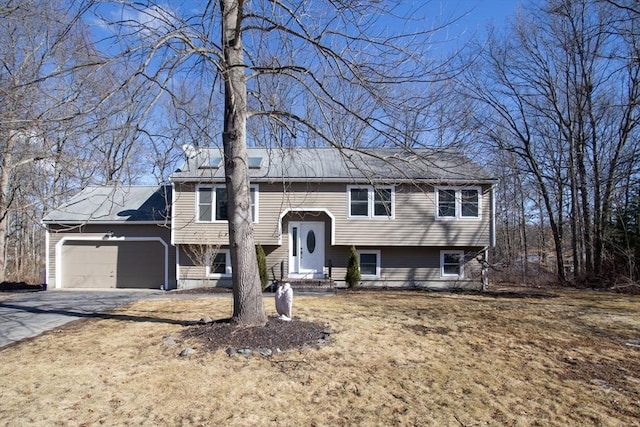 bi-level home with a garage and driveway