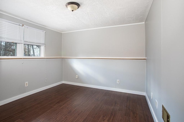 spare room with baseboards, a textured ceiling, visible vents, and wood finished floors