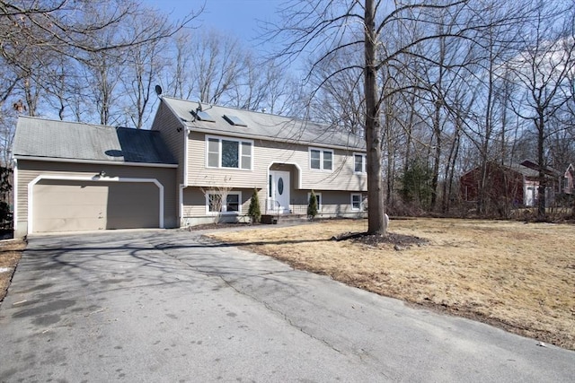 split foyer home featuring a garage and driveway