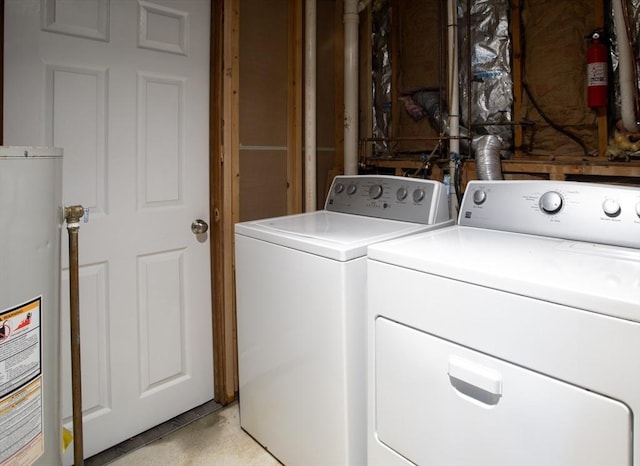 laundry area featuring laundry area, water heater, and washer and clothes dryer