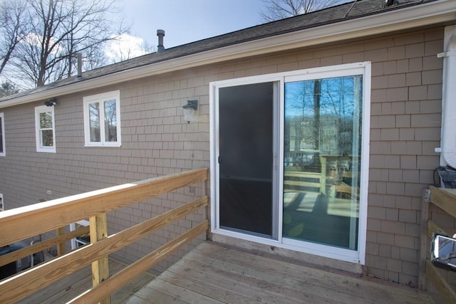 view of exterior entry featuring a wooden deck