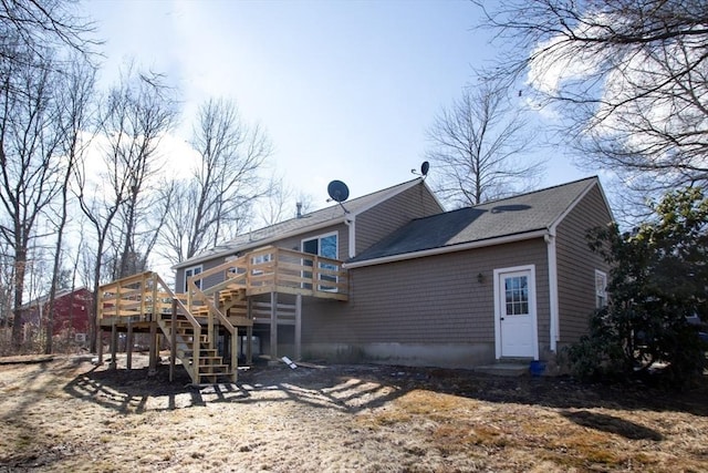 rear view of house featuring a deck and stairway