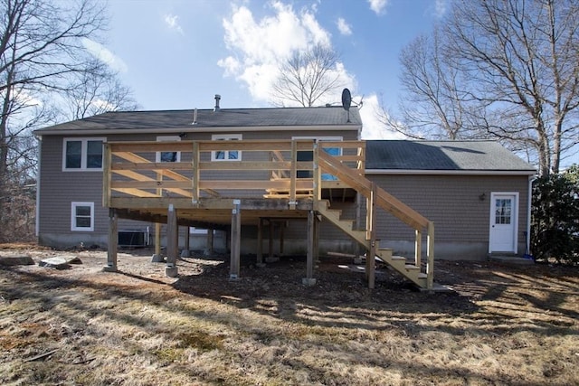 rear view of property with stairs and a deck