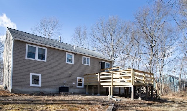 rear view of house with central AC unit, stairway, and a wooden deck