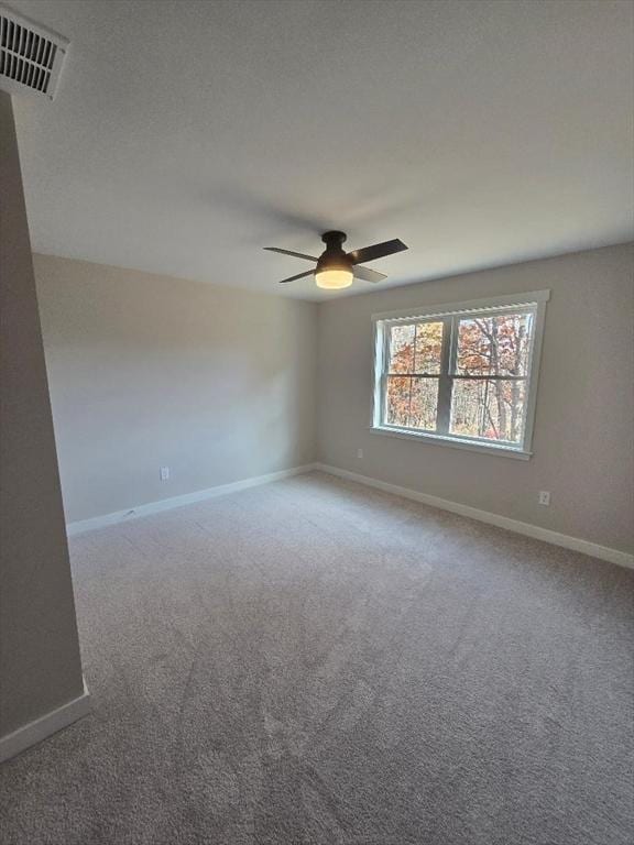 carpeted spare room featuring a textured ceiling and ceiling fan