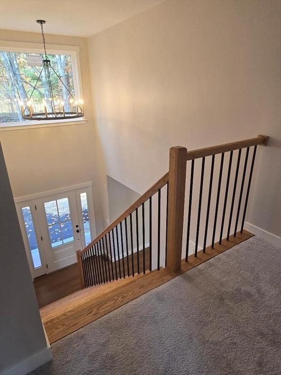 stairs featuring a towering ceiling and carpet