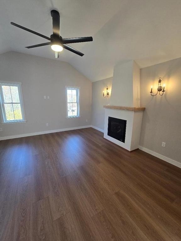 unfurnished living room with ceiling fan, lofted ceiling, and dark hardwood / wood-style floors