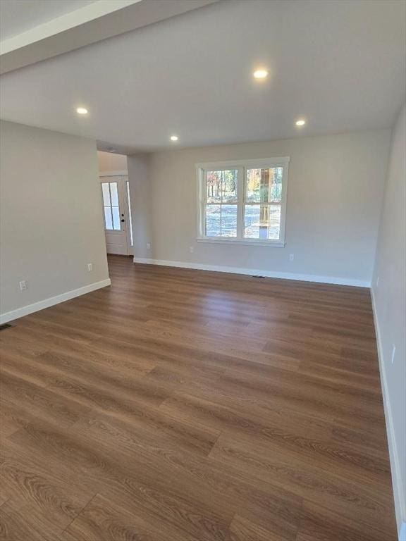 unfurnished room with dark hardwood / wood-style flooring