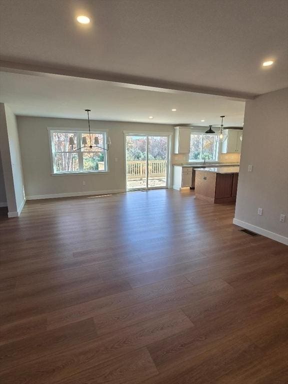 unfurnished living room featuring dark wood-type flooring