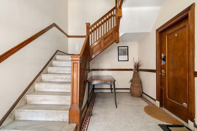 staircase with baseboards, carpet floors, and baseboard heating